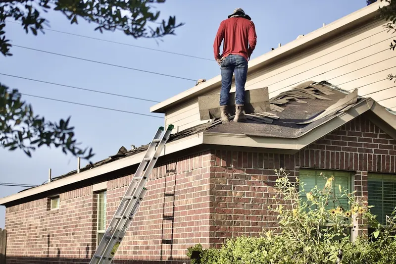 Professional roofer working on a residential roof in Auburn Hills